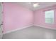 Bright bedroom features a ceiling fan, window with blinds, and light-colored tile flooring at 113 Azure Mist Way, Daytona Beach, FL 32124