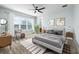 Stylized primary bedroom with a ceiling fan, neutral walls, and a view of the lake at 113 Azure Mist Way, Daytona Beach, FL 32124