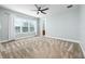 This bedroom features neutral carpet, a ceiling fan, and access to the bathroom at 113 Azure Mist Way, Daytona Beach, FL 32124