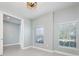 A modern bedroom with natural light featuring neutral colors and a ceiling fan at 113 Azure Mist Way, Daytona Beach, FL 32124