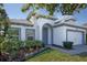 Charming single-story home with a well-manicured lawn and blue accented trim at 113 Azure Mist Way, Daytona Beach, FL 32124
