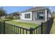 A rear exterior view of the home with a covered patio and fenced backyard at 113 Azure Mist Way, Daytona Beach, FL 32124