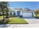 Charming single-Gathering home boasts a well-manicured lawn and welcoming curb appeal at 113 Azure Mist Way, Daytona Beach, FL 32124