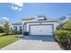 Attractive home exterior showcasing a spacious driveway leading to a two-car garage at 113 Azure Mist Way, Daytona Beach, FL 32124