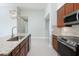 A modern kitchen features stainless steel appliances, granite countertops and decorative pendant lights at 113 Azure Mist Way, Daytona Beach, FL 32124