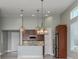 A modern kitchen features stainless steel appliances, granite countertops and decorative pendant lights at 113 Azure Mist Way, Daytona Beach, FL 32124