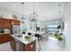Spacious open-concept kitchen with granite countertops, stainless steel appliances, and a view of the living space at 113 Azure Mist Way, Daytona Beach, FL 32124