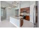 A modern kitchen features stainless steel appliances, granite countertops and decorative pendant lights at 113 Azure Mist Way, Daytona Beach, FL 32124