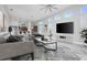 Stylish living room with modern furniture, large windows, and an open layout to the kitchen at 113 Azure Mist Way, Daytona Beach, FL 32124