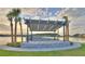 Lakeside pavilion has an outdoor kitchen area, beautiful landscaping, and a lake view at 113 Azure Mist Way, Daytona Beach, FL 32124