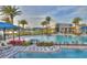 Community pool with inviting lounge chairs, lush landscaping, and an outdoor kitchen area at 113 Azure Mist Way, Daytona Beach, FL 32124