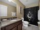 Cozy bathroom featuring a granite countertop, a decorative shower curtain, and modern fixtures at 1144 Legg Dr, Apopka, FL 32712
