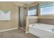 Bathroom featuring a glass enclosed shower, a soaking tub, and a window at 1144 Legg Dr, Apopka, FL 32712