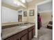 Bathroom vanity with granite counters, white cabinets, and decorative wall art at 1144 Legg Dr, Apopka, FL 32712