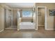 Bright bathroom featuring a shower, soaking tub, and a window at 1144 Legg Dr, Apopka, FL 32712