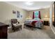 Comfortable bedroom featuring a queen bed, chair, and tasteful decor at 1144 Legg Dr, Apopka, FL 32712