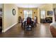 Formal dining room with wood floors, elegant lighting, and large windows at 1144 Legg Dr, Apopka, FL 32712