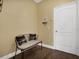 Inviting entryway with bench, stylish decor, and wood-look floors at 1144 Legg Dr, Apopka, FL 32712