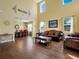 Open-concept living room with wood floors flowing into the dining room at 1144 Legg Dr, Apopka, FL 32712
