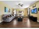 Comfortable living room featuring wood floors, ceiling fan, and modern decor at 1144 Legg Dr, Apopka, FL 32712
