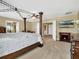 Spacious main bedroom features a four-poster bed, carpet, TV, and ensuite bathroom access at 1144 Legg Dr, Apopka, FL 32712