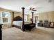 Main bedroom with a luxurious four-poster bed, carpet and windows with lots of natural light at 1144 Legg Dr, Apopka, FL 32712