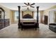 Large main bedroom with four-poster bed, carpet, and natural light from large windows at 1144 Legg Dr, Apopka, FL 32712