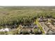 An aerial view of a condominium complex next to a beautiful forest and pond at 11901 Sandy Knoll Ct # 814, Orlando, FL 32825