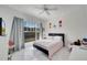 Bedroom with a large window, plush bedding, cool toned accents, and white tile flooring at 11901 Sandy Knoll Ct # 814, Orlando, FL 32825