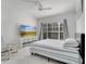 Bright bedroom featuring a TV, ceiling fan, and large window at 11901 Sandy Knoll Ct # 814, Orlando, FL 32825