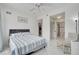Bright bedroom showcasing an ensuite bathroom and kitchen access at 11901 Sandy Knoll Ct # 814, Orlando, FL 32825
