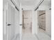 Hallway view to bathroom with toilet and glass enclosed shower at 11901 Sandy Knoll Ct # 814, Orlando, FL 32825