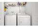 Functional laundry room with side-by-side washer and dryer units and a storage shelf at 11901 Sandy Knoll Ct # 814, Orlando, FL 32825