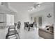 Open-concept living area featuring a dining table, comfortable sofa, and kitchen bar at 11901 Sandy Knoll Ct # 814, Orlando, FL 32825