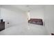 Bright living room showcasing a brown leather couch, modern ceiling fan, and clean, white tile flooring at 11901 Sandy Knoll Ct # 814, Orlando, FL 32825