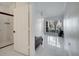 Open-concept living room with a modern tile floor flowing into a hallway and bathroom at 11901 Sandy Knoll Ct # 814, Orlando, FL 32825
