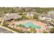 Aerial view of a community pool and lounging area, surrounded by palm trees and lush landscaping at 11901 Sandy Knoll Ct # 814, Orlando, FL 32825