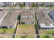 An aerial view of a house's backyard, featuring a clean, fenced yard and a glimpse of the surrounding neighborhood at 1260 Tupelo Trl, Haines City, FL 33844