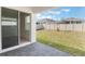 A view of the backyard and patio area, with a white fence at 1260 Tupelo Trl, Haines City, FL 33844
