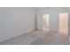 Bright bedroom with neutral carpet and doors to the bathroom and hallway at 1260 Tupelo Trl, Haines City, FL 33844