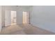 Well-lit bedroom with neutral carpet and doors to the bathroom and hallway at 1260 Tupelo Trl, Haines City, FL 33844