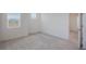 Bedroom with neutral carpet, small window and a door to another room at 1260 Tupelo Trl, Haines City, FL 33844