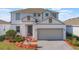 Beautiful two-story home with manicured landscaping and a two-car garage at 1260 Tupelo Trl, Haines City, FL 33844