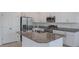 Close up view of the kitchen's island with stainless steel sink and faucet, with granite countertop at 1260 Tupelo Trl, Haines City, FL 33844