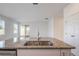 Close up view of kitchen island with stainless steel sink and faucet, and granite countertop at 1260 Tupelo Trl, Haines City, FL 33844