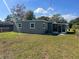 Spacious backyard featuring a screened-in porch and a lush grassy area at 1315 Carlsbad Pl, Orlando, FL 32808