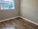 A comfortable bedroom offers natural light and stylish wood-look flooring at 1315 Carlsbad Pl, Orlando, FL 32808