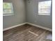 This bedroom features two windows, wood-look flooring, and neutral-colored walls at 1315 Carlsbad Pl, Orlando, FL 32808
