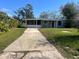 Charming single-story home with a long driveway and enclosed porch at 1315 Carlsbad Pl, Orlando, FL 32808