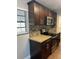 Gourmet kitchen featuring dark wood cabinets and stainless steel appliances at 1315 Carlsbad Pl, Orlando, FL 32808
